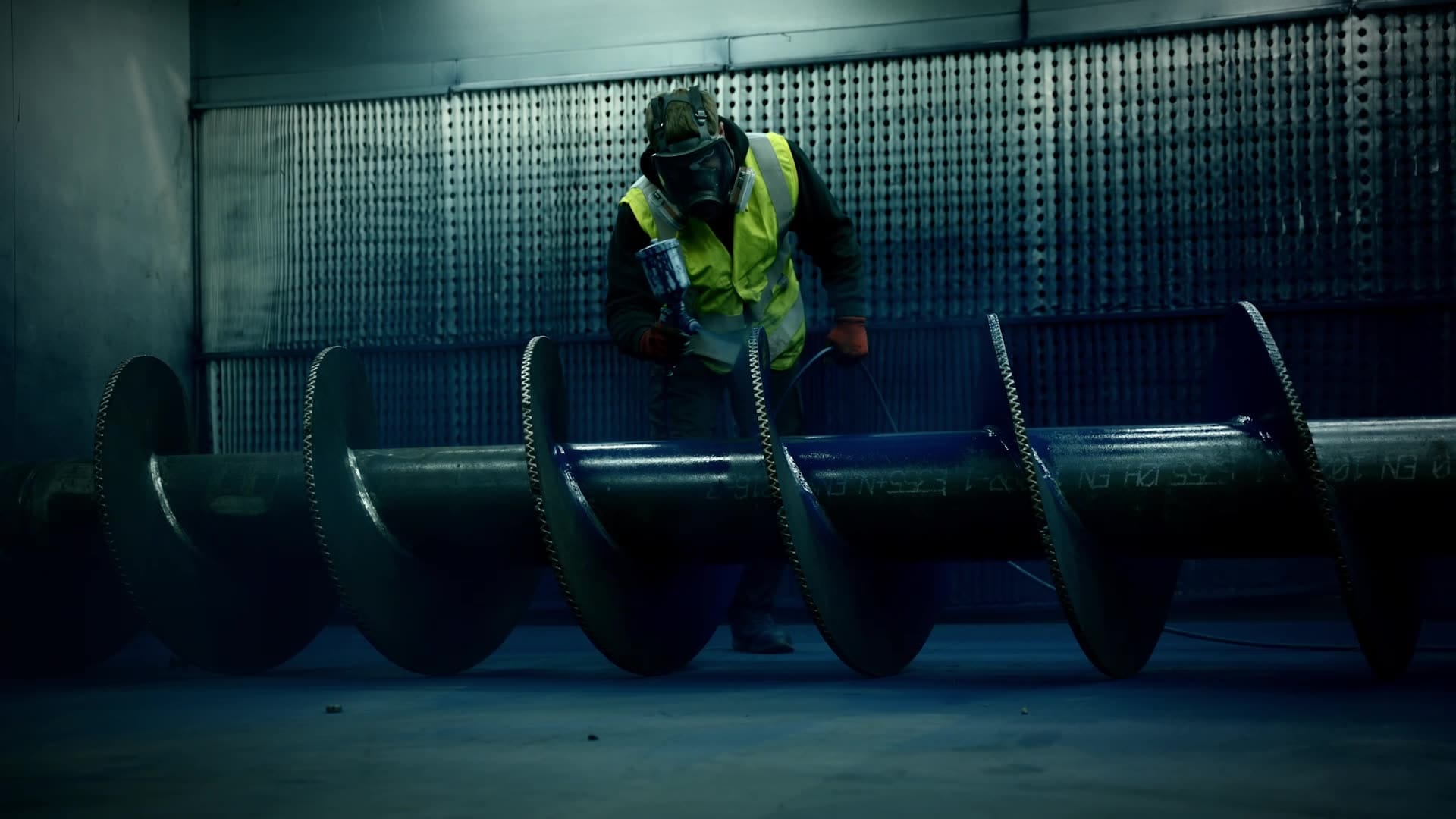 man mask spray painting blue high-vis