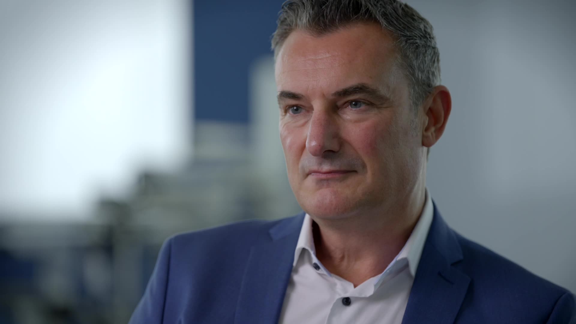 man blue suite interview close-up