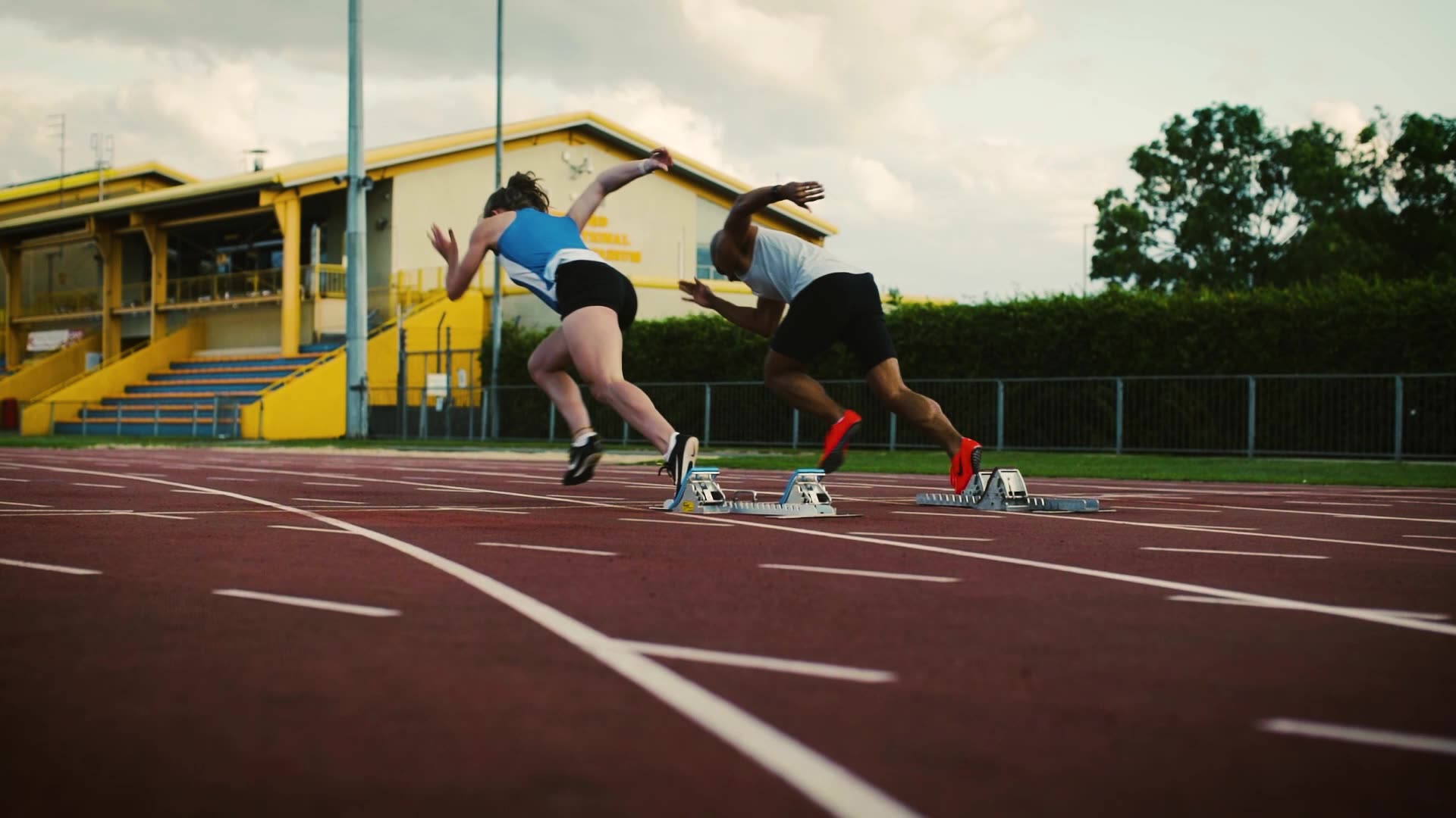 man woman race track running
