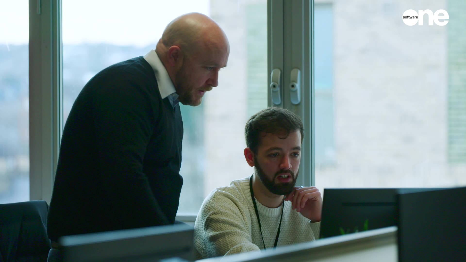 men talking corporate work computer screen