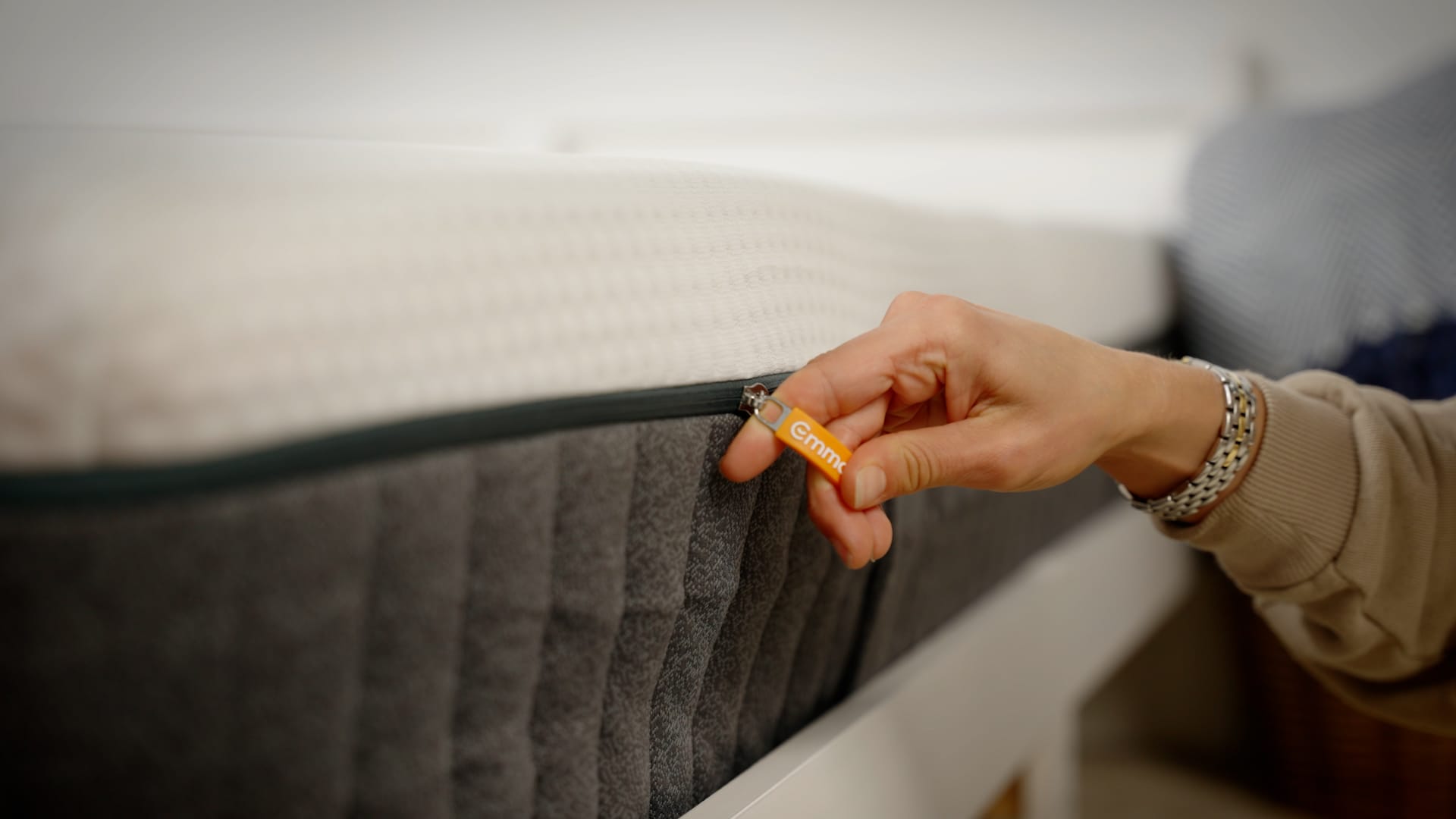 mattress zip logo hand